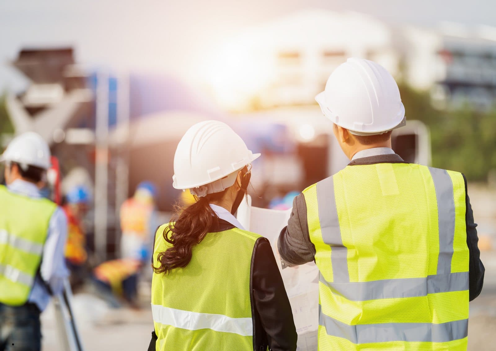 Two construction professionals in safety vests walking a job site