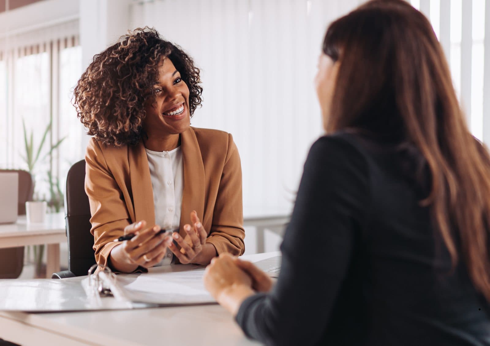 Two professionals having a friendly meeting at an office desk