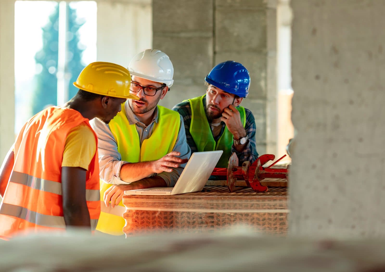 Special inspectors reviewing structural work with a laptop on a high-rise site